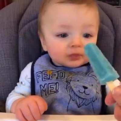 Little man trying a popsicle for the first time