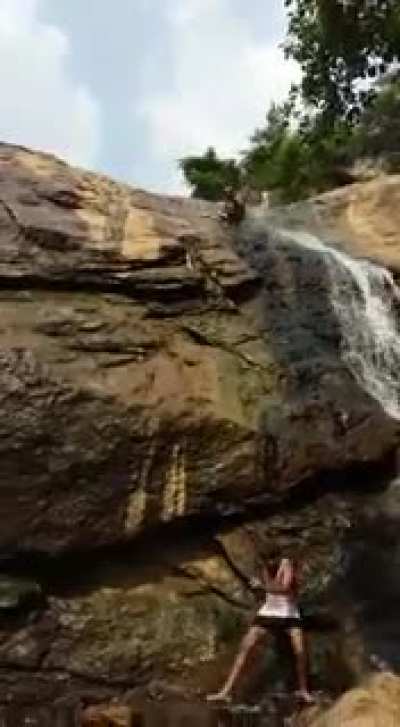 Man falling down rocky waterfall