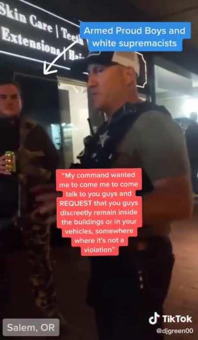POLICE OFFICER TELLS PROUD BOYS TO HIDE INSIDE BUILDING BECAUSE THEY'RE ABOUT TO TEAR GAS PROTESTERS. THE OFFICER SAID HE WAS WARNING THEM 