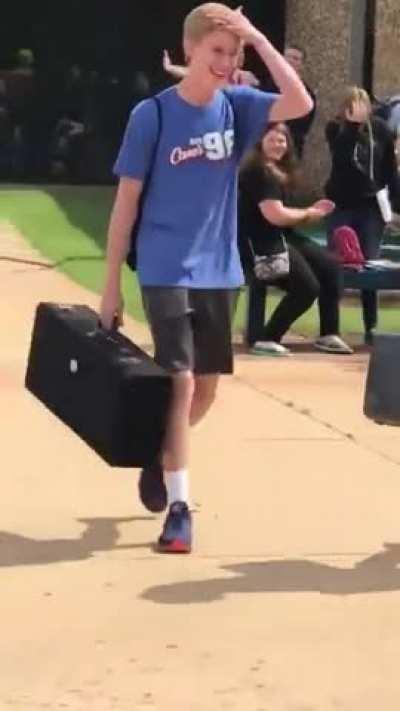 Dad picking up son from school in speedo