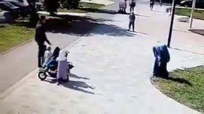 Woman beaten in public in front of her children