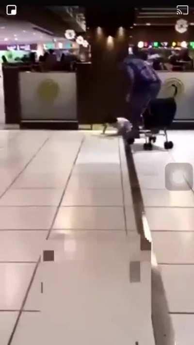 Hitting his kid with a stroller for crying in a shopping mall