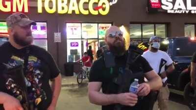 Only in the USA: Heavily armed rednecks guarding residents against police and looters