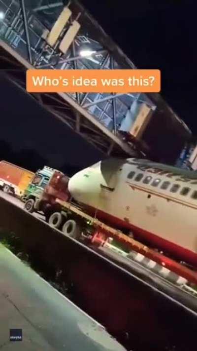Trying to go under a bridge while transporting an airplane