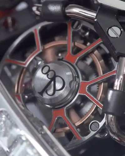 The Black and Organe Toubillion Baguette, that replicates the mechanics of the iconic W16 Bugatti engine ($750K+).