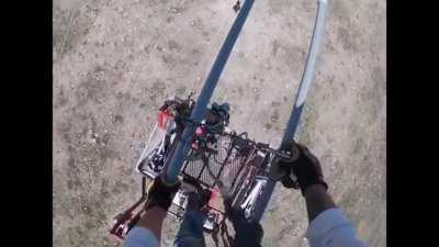 Lineman’s cart slips off the wires. He has to fix it so he get get off the lines.