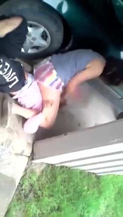 girls fight in the car port