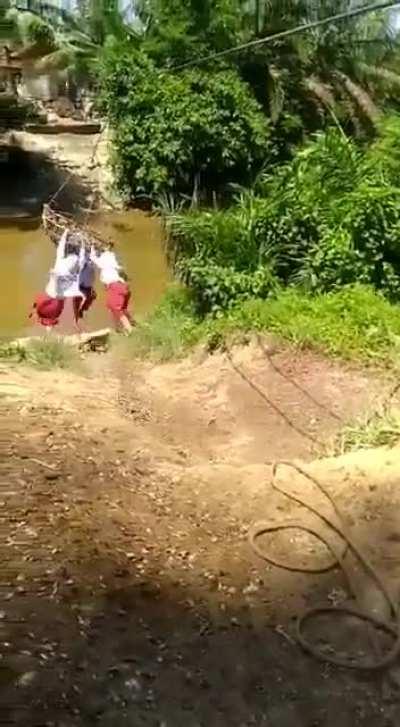 Schoolchildren in a remote Indonesian village have to go 