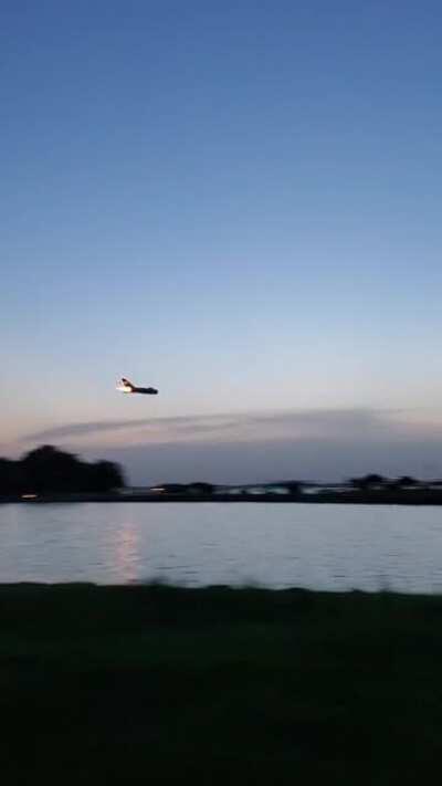 MiG-17 over a lake at twilight