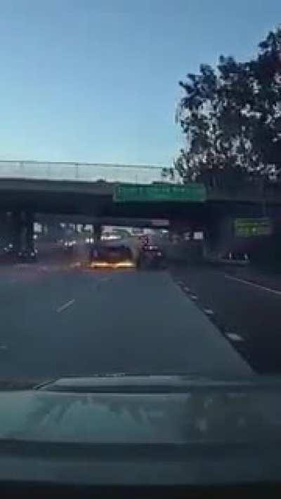 Guy in suv speeds up to prevent a merge, flips on his side