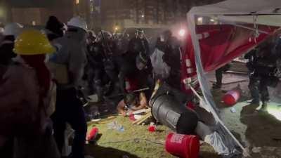 Riot Police breaks through UCLA encampment to detain students.