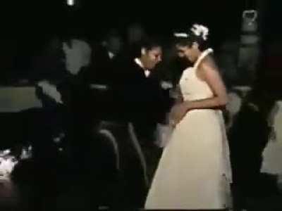 Carrying fancy flaming drinks in a wedding dress isn’t the best idea.