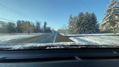 Driving on the wrong side of the road, windshield covered in snow