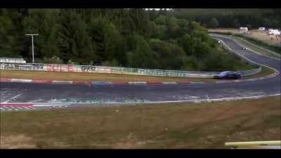 Standing outside the safety barrier of a race track, WCGW