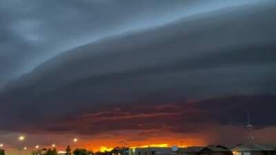 Shelf cloud with a sunset in the background