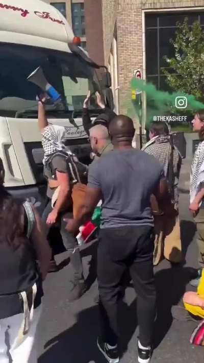 People in the UK attempt to clear the road of protesters