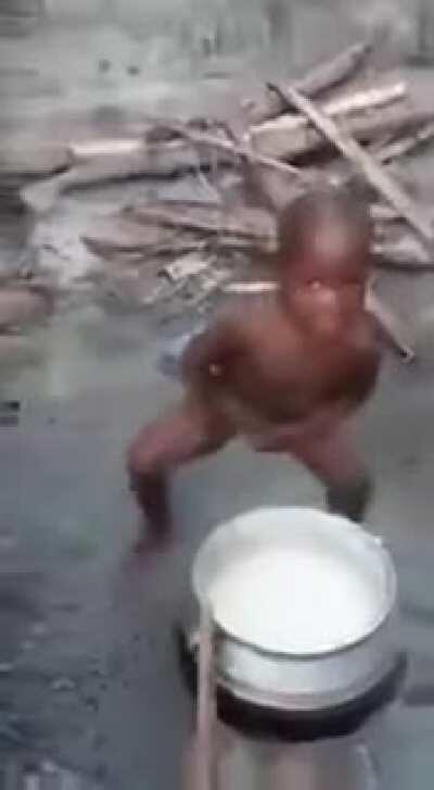 Letting a naked child stir a hot pot