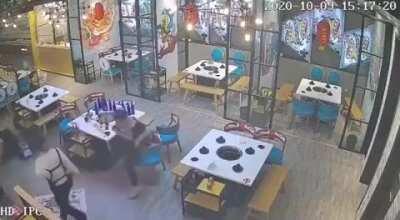 Two guys get served by a waitress