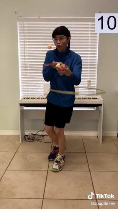 This dude hula hoops,balances a ping pong ball and solves a rubix cube with one hand at the same time