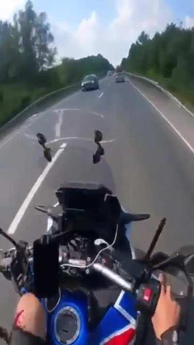 Rider gets clipped while overtaking an 18-wheeler 