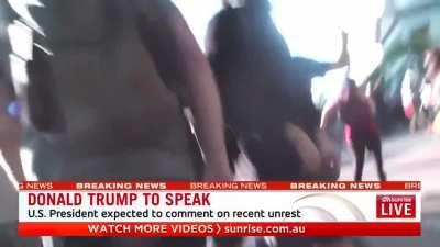 Cameraman POV, getting punched straight in the face by cops.