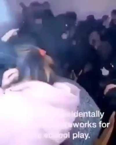 Lighting a fireworks in a school play.