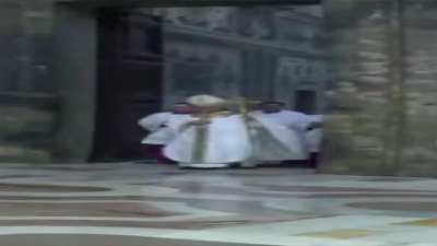 Wide Pope Leo XIV walking to bless us all.