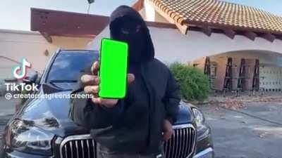 Kanye showing something on his phone