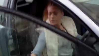 Woman holding a child spits on man after being confronted for parking on his property…