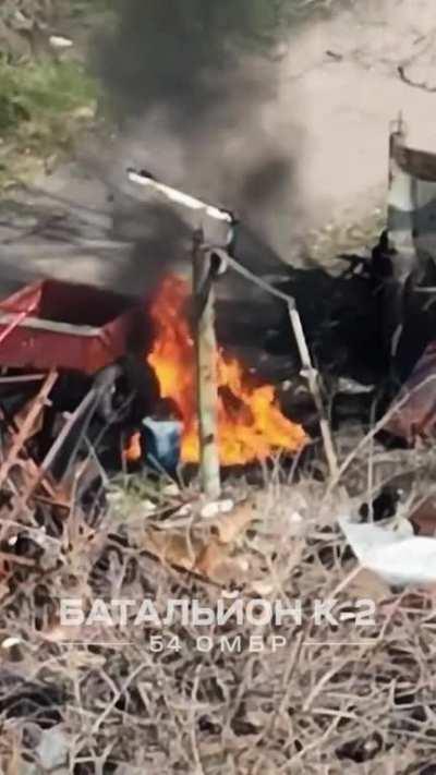 Ukrainian drone drops grenades on some type of improvised vehicle transporting diesel containers.