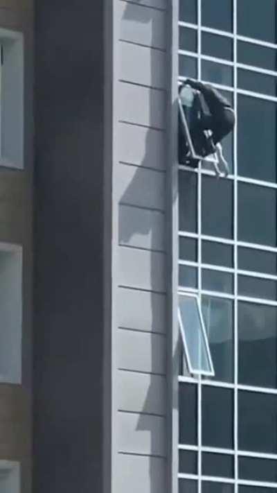 The man climbed out of his eighth floor apartment window to catch the helpless three-year-old girl.