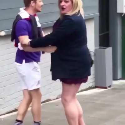 Couple of people have a fight and argument in public, UK