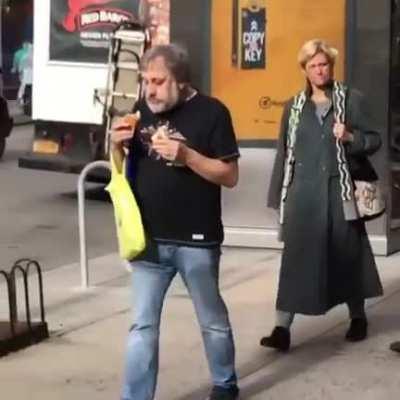 Zizek double fisting two hotdogs
