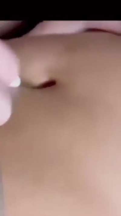 piercing her deep navel base