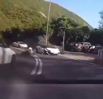 crazy dude on motorcycle crashes into expensive car