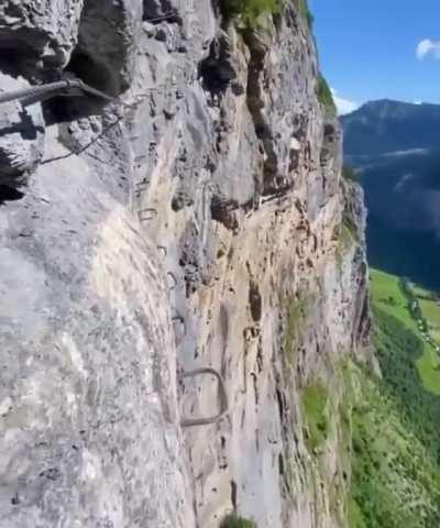 Hiking path alongside vertical cliff in Switzerland