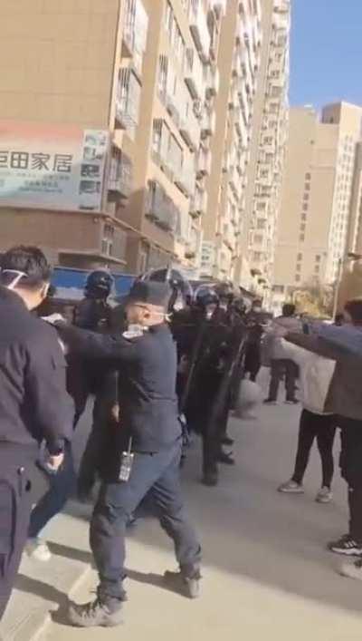girl roughed up and taken away by baton-wielding police