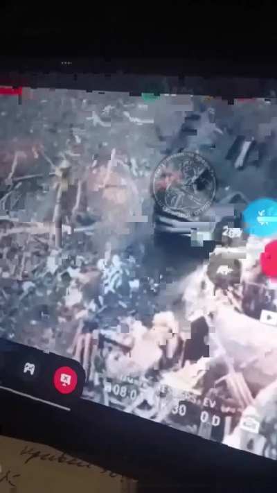 A Russian drone team observes a UAF soldier outside his position. The drone feed is seen being recorded in real time by the operators as the drone heads toward the soldier