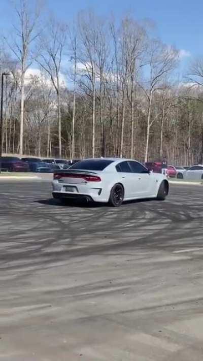 Camaro doing donuts crashes into a hellcat