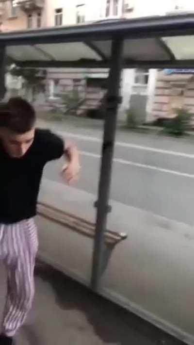 Trying to break reinforced glass at bus stop