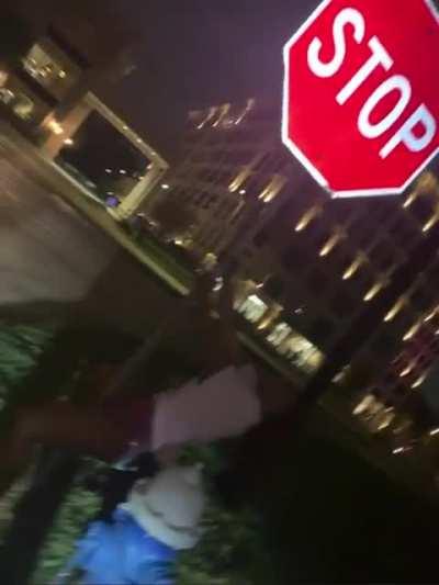 Megan dancing on a stop sign