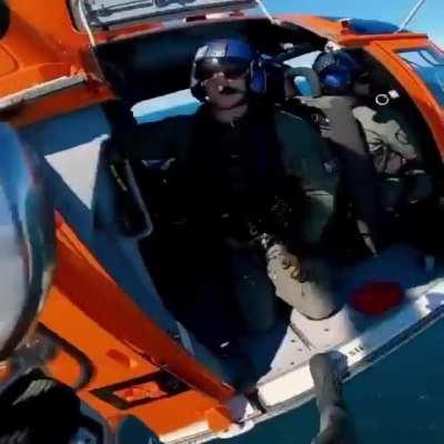 USCG rescue swimmer hoists down to an 800’+ tall offshore windmill as part of a training evolution