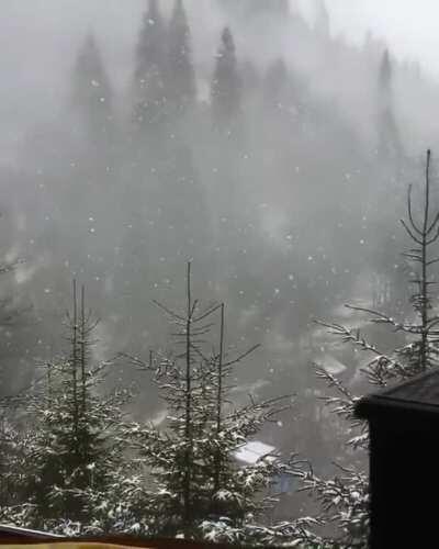Cozy warm cabin with a fireplace and snow outside