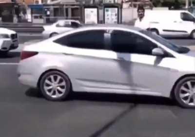 A guy prays in the middle of the street. 