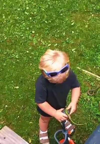 Kid perfectly imitating the sound of a lawn cutter