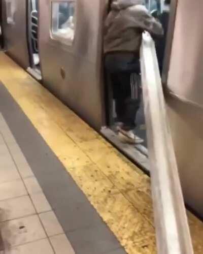 NYC Entrepreneur is seen on his way to the nearest $crap metal recovery $hop via the MTA $ubway. Of course kind New Yorkers lend a hand to get it fully loaded into the tight subway car.
