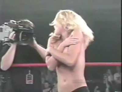 Getting her top removed during a wrestling match