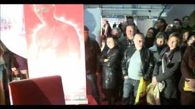 She sucks his balls and gives him a BJ in front of a crowd