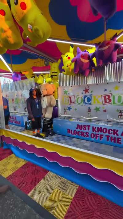 Playing knock all the blocks of the table, at a Fair