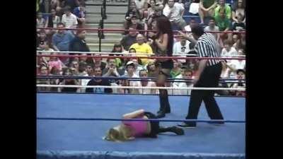 Velvet Sky held down by Christy Hemme's foot in her crotch in the corner